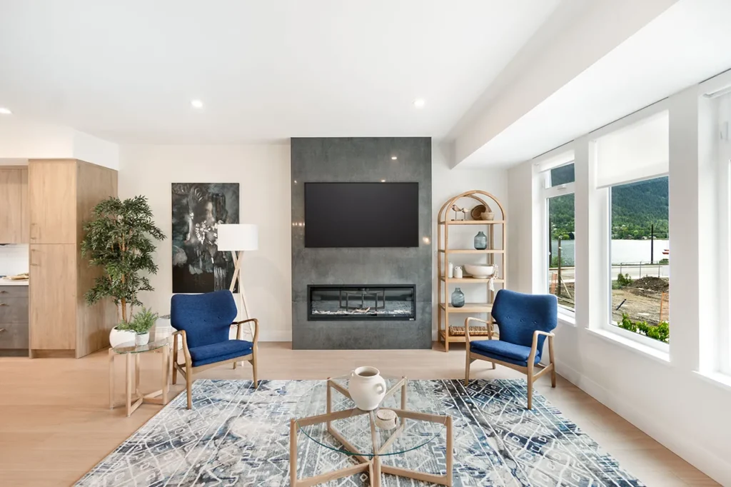 Living room showing the seating area, fireplace, and view of the lake through the windows